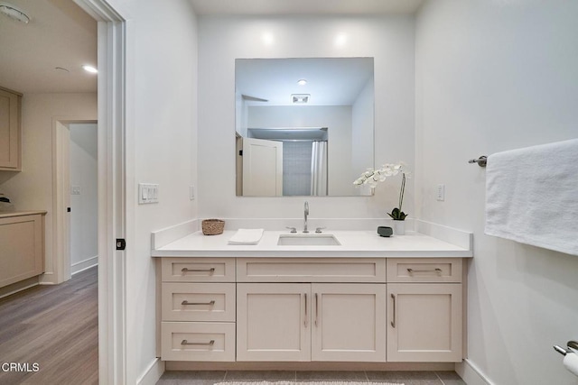 bathroom with hardwood / wood-style flooring and vanity