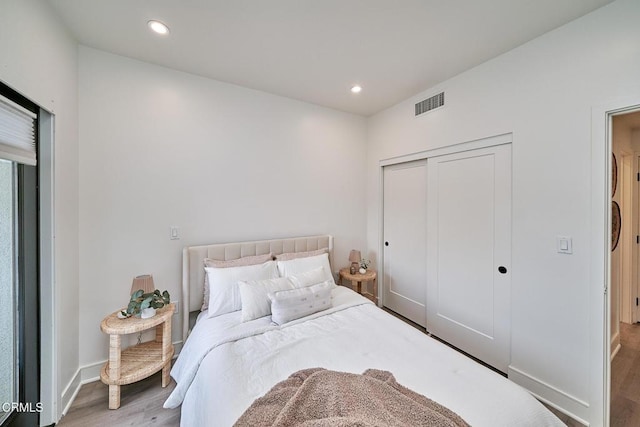 bedroom with hardwood / wood-style flooring and a closet