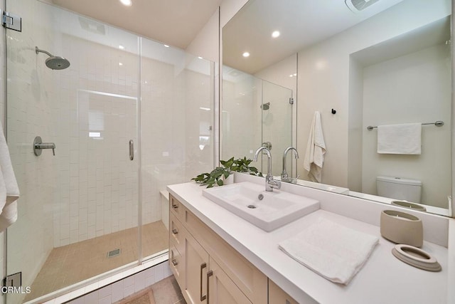 bathroom with vanity, toilet, walk in shower, and tile patterned floors