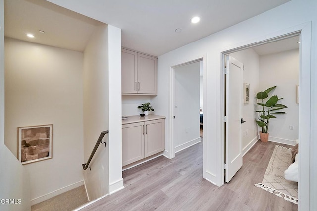 corridor with light hardwood / wood-style flooring