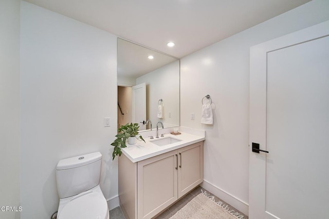 bathroom with toilet and vanity