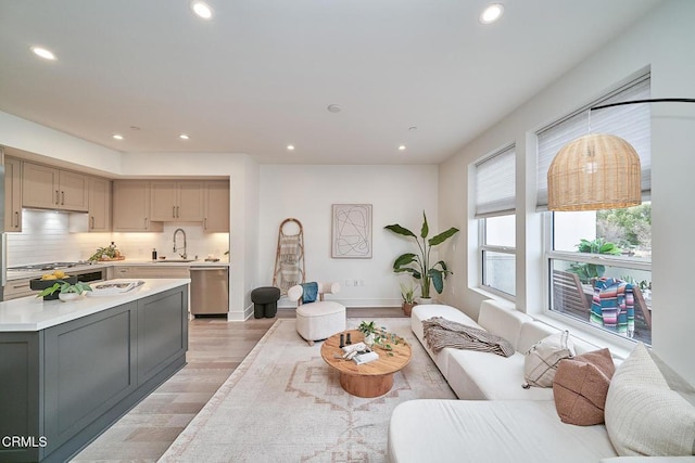 living room with sink and light wood-type flooring