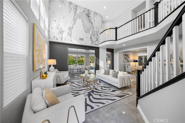 living room featuring a towering ceiling