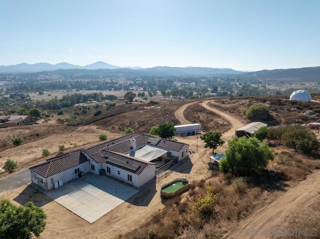 birds eye view of property featuring a mountain view