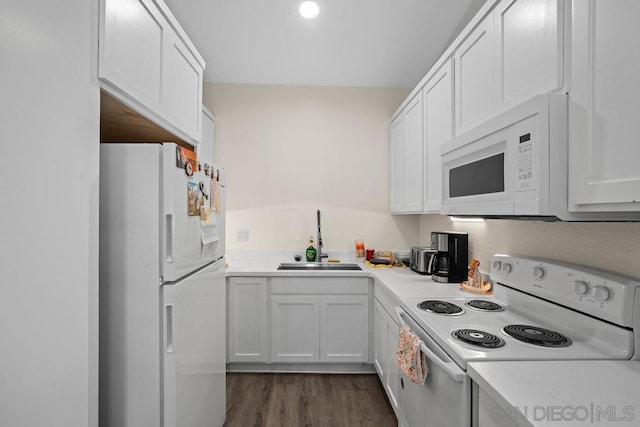 kitchen featuring sink, white appliances, white cabinets, and dark hardwood / wood-style floors