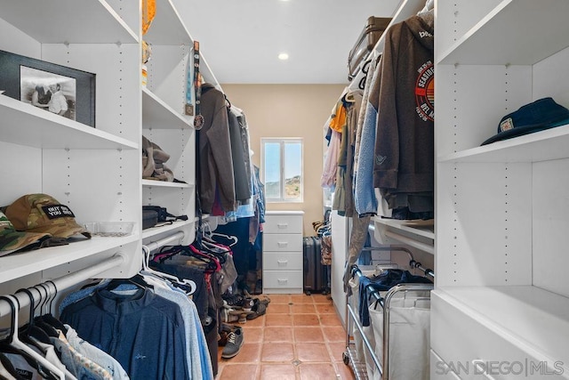 walk in closet with tile patterned flooring