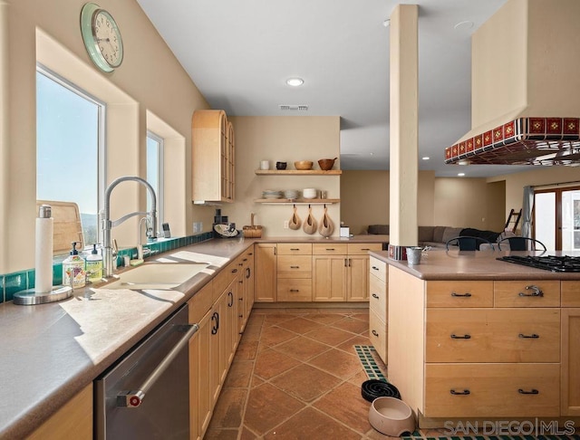 kitchen featuring light brown cabinetry, dark tile patterned floors, sink, extractor fan, and stainless steel appliances