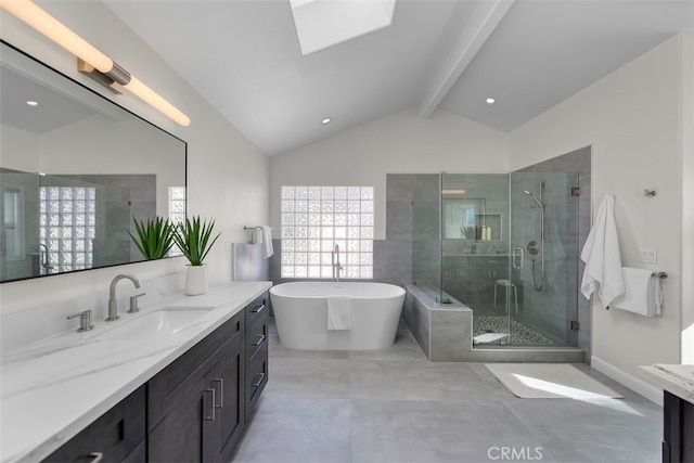 bathroom with vaulted ceiling with skylight, vanity, and shower with separate bathtub