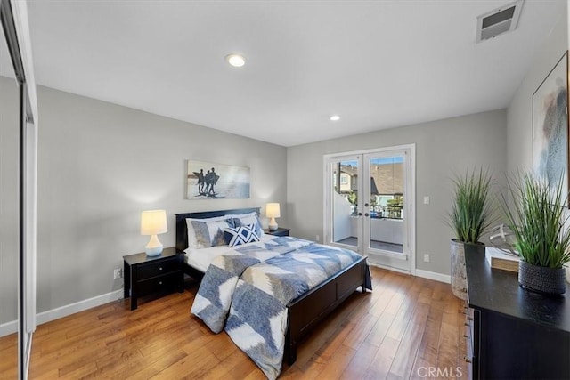 bedroom with hardwood / wood-style flooring, access to exterior, and french doors