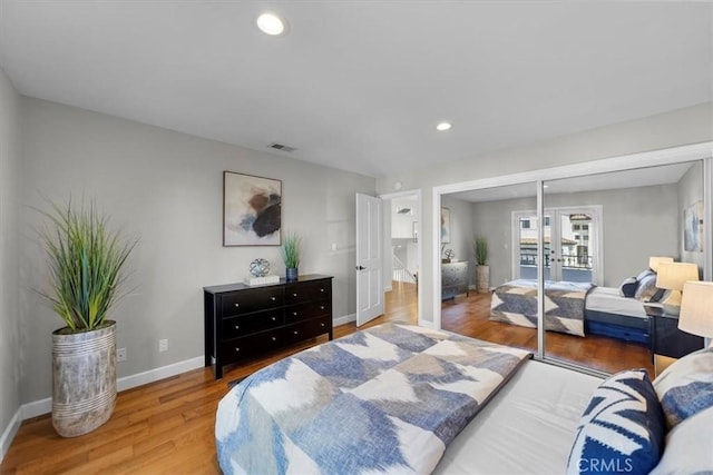 bedroom featuring a closet, french doors, and hardwood / wood-style floors