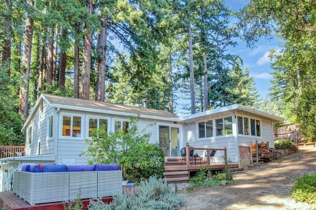 back of house with outdoor lounge area and a wooden deck