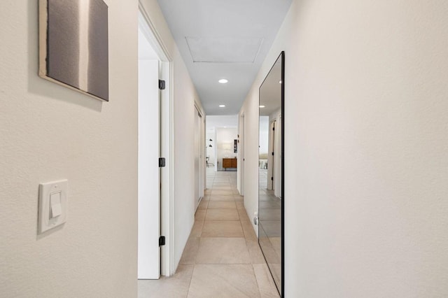 hall with light tile patterned floors