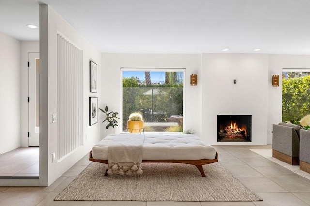 bedroom with light tile patterned floors and multiple windows