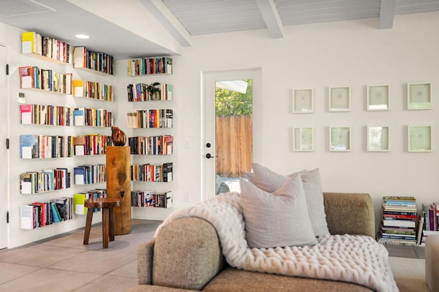 living area featuring lofted ceiling with beams, wood ceiling, and light tile patterned flooring