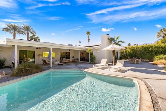 view of pool with a patio, an outdoor hangout area, and ceiling fan