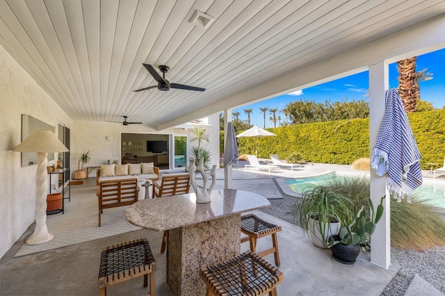 view of patio with ceiling fan, a fenced in pool, and an outdoor hangout area