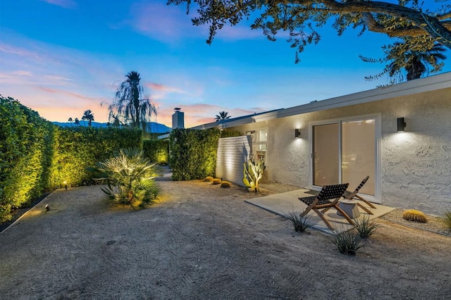 yard at dusk with a patio area