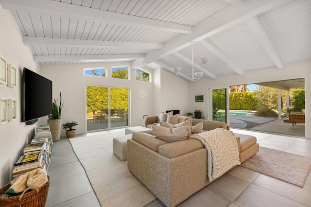 tiled living room featuring high vaulted ceiling and beamed ceiling