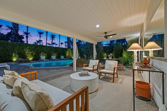 patio terrace at dusk with ceiling fan, a fenced in pool, and an outdoor living space