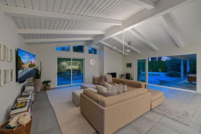 living room featuring lofted ceiling with beams and light tile patterned floors