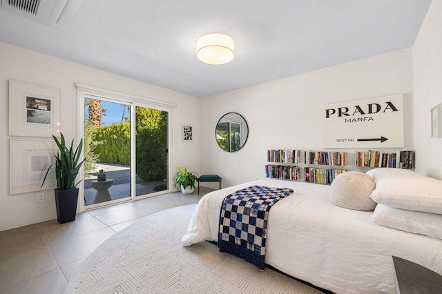 bedroom featuring access to exterior and light tile patterned floors