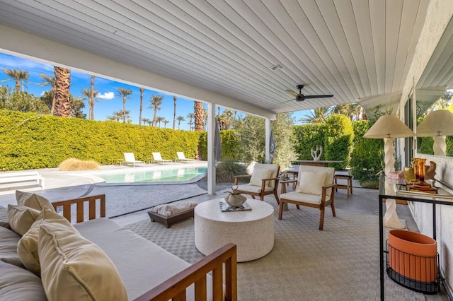 view of patio with an outdoor living space, a fenced in pool, and ceiling fan