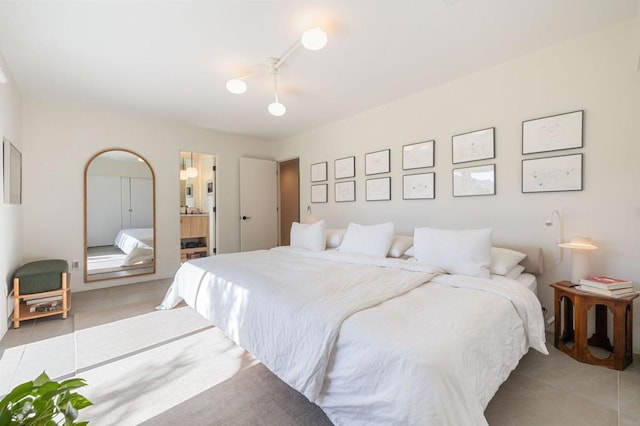 tiled bedroom featuring ensuite bathroom