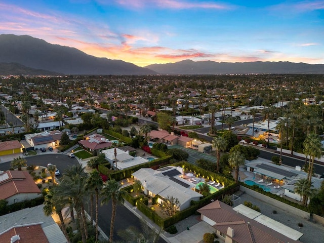 aerial view at dusk featuring a mountain view