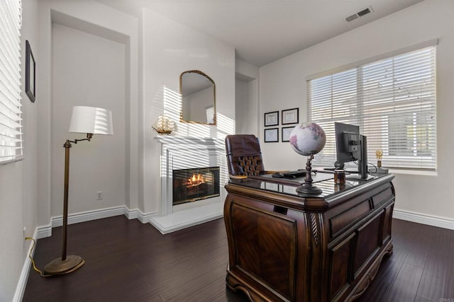 office space with dark wood-type flooring