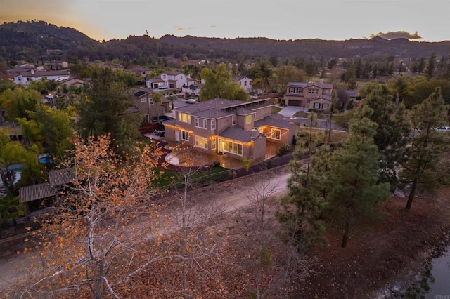 aerial view at dusk featuring a mountain view