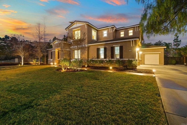 view of front of house featuring a garage and a yard