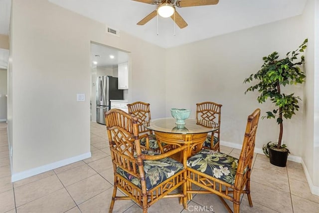 dining room with light tile patterned floors and ceiling fan