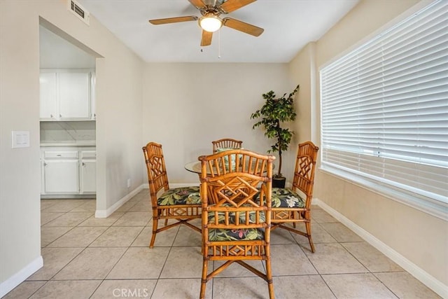 tiled dining space featuring ceiling fan