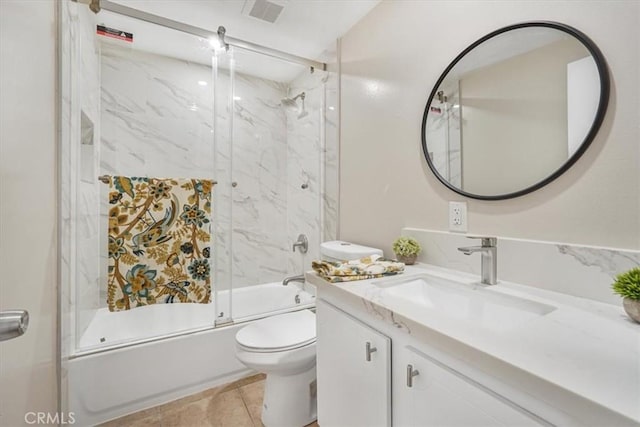 full bathroom with enclosed tub / shower combo, vanity, tile patterned floors, and toilet