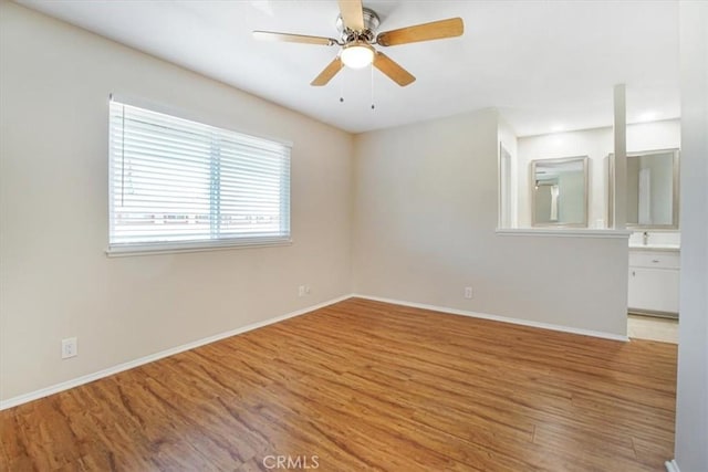 empty room featuring ceiling fan and light hardwood / wood-style flooring