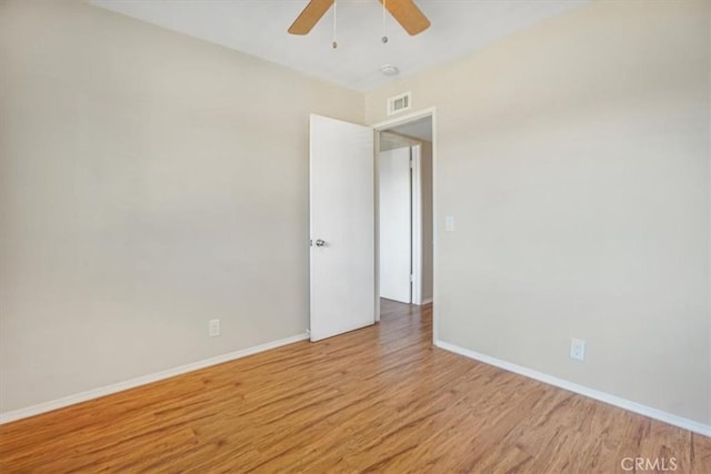 empty room featuring ceiling fan and light hardwood / wood-style floors