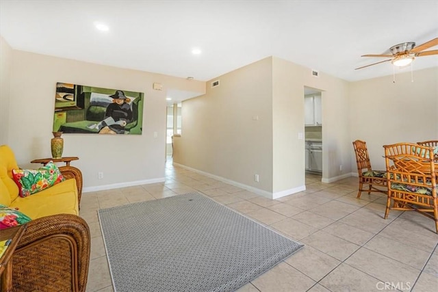 living area featuring light tile patterned flooring and ceiling fan