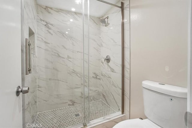 bathroom with walk in shower and toilet