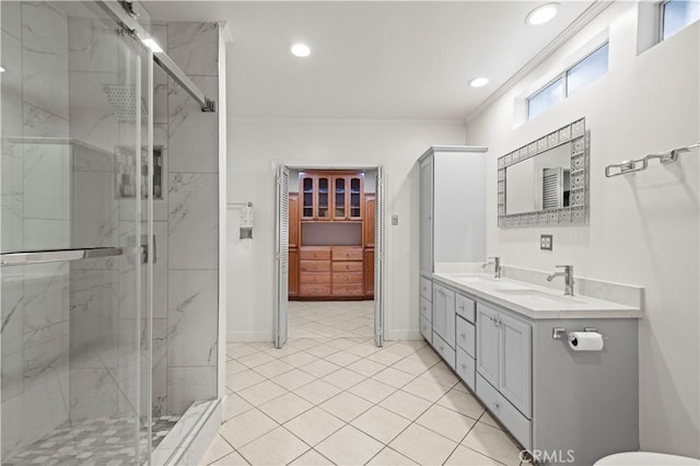 bathroom featuring crown molding, a shower with door, tile patterned flooring, and vanity