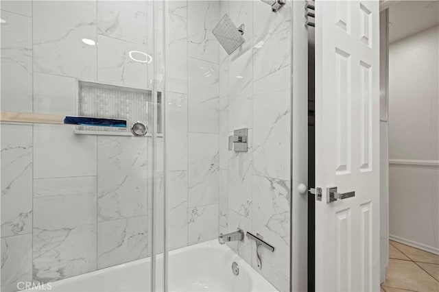 bathroom featuring tiled shower / bath combo and tile patterned floors