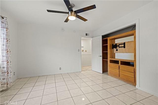 unfurnished bedroom with ceiling fan and light tile patterned flooring