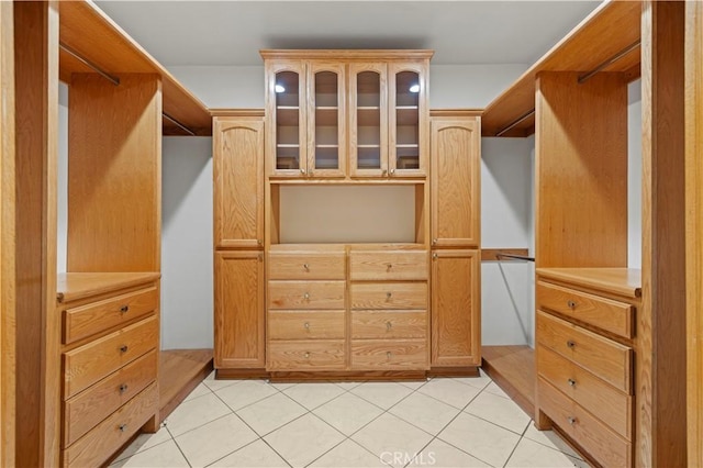 walk in closet with light tile patterned flooring