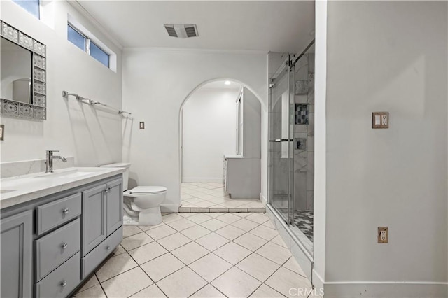 bathroom with an enclosed shower, vanity, toilet, and tile patterned flooring