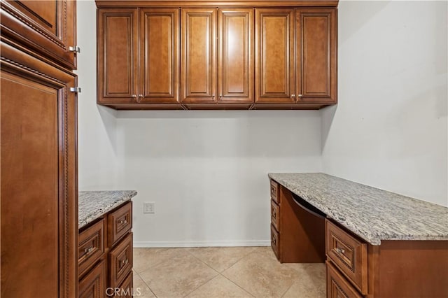 clothes washing area featuring light tile patterned floors