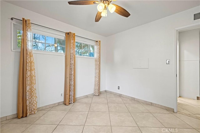 unfurnished room with ceiling fan and light tile patterned flooring