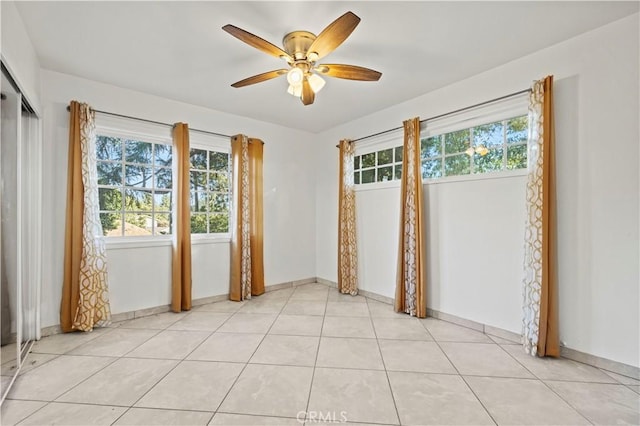 empty room featuring ceiling fan and light tile patterned floors