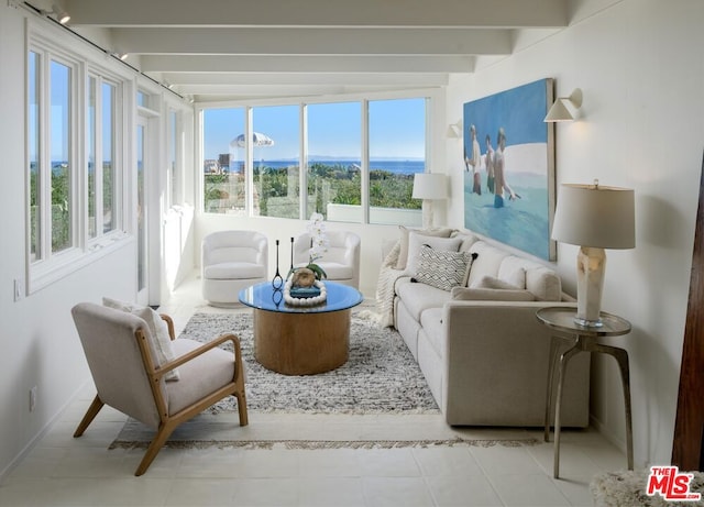 sunroom featuring plenty of natural light and beamed ceiling