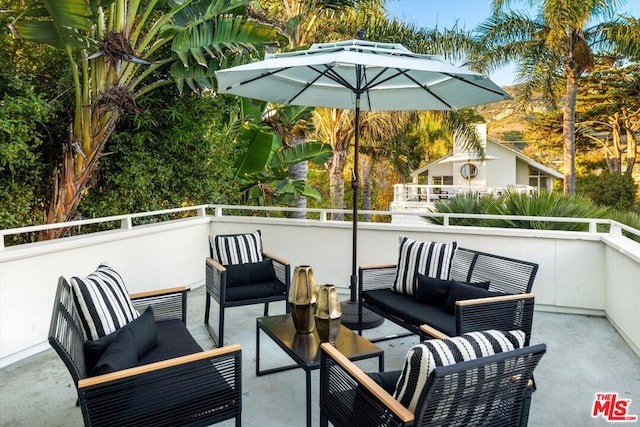 view of patio / terrace featuring a balcony and an outdoor living space