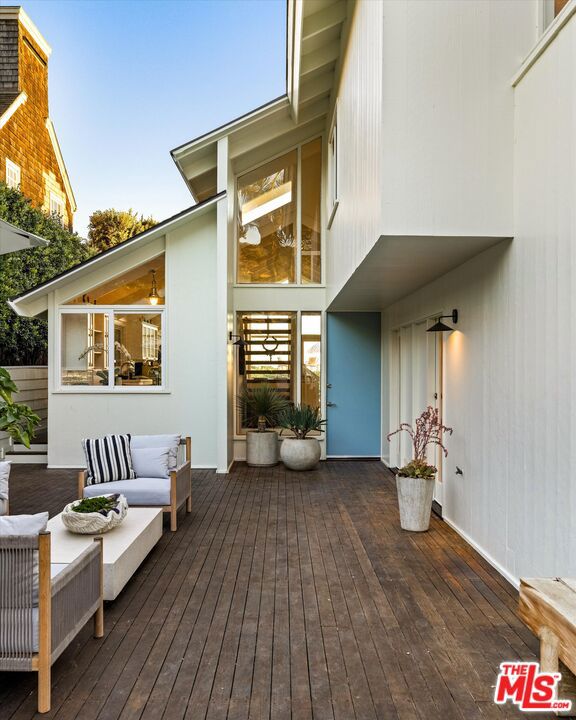 wooden terrace featuring an outdoor hangout area