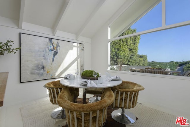 sunroom / solarium featuring lofted ceiling with beams